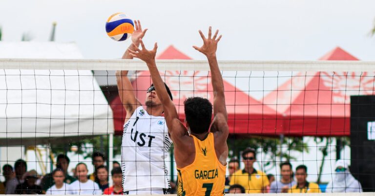 Beach volleyball action shot of two players competing at a tournament in Pasay, Philippines.