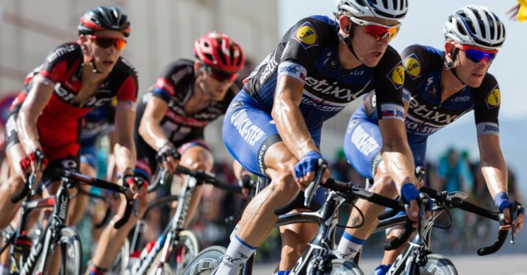 Competitive cyclists in a high-speed race, showcasing athleticism and teamwork.