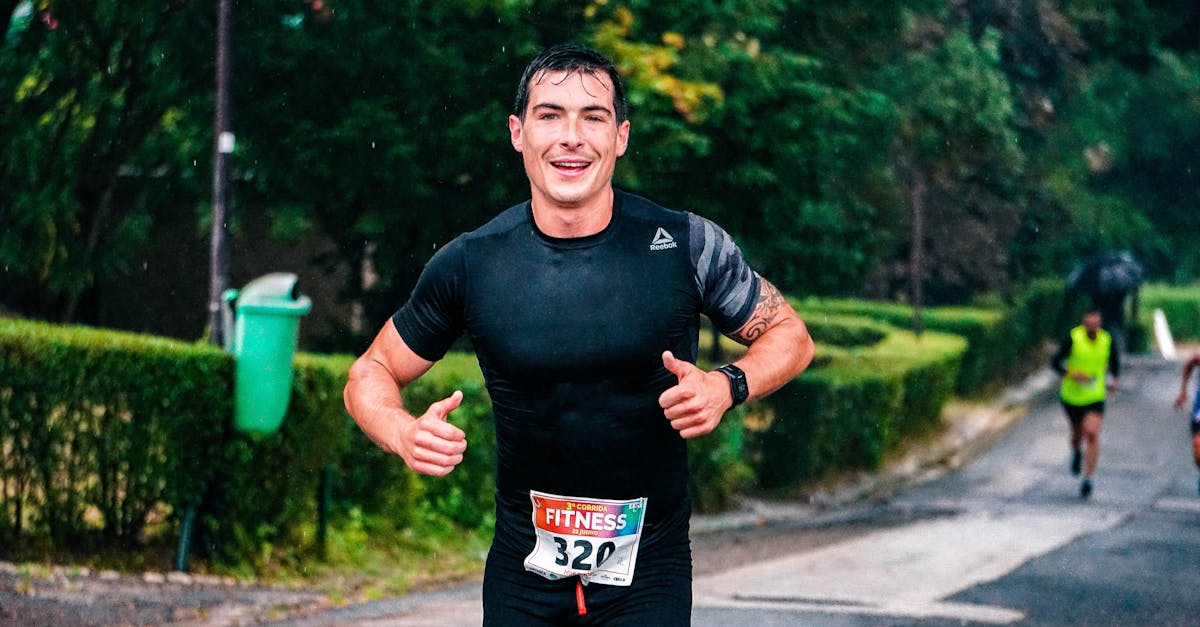 A fit male runner participating in an outdoor marathon during rainy conditions.