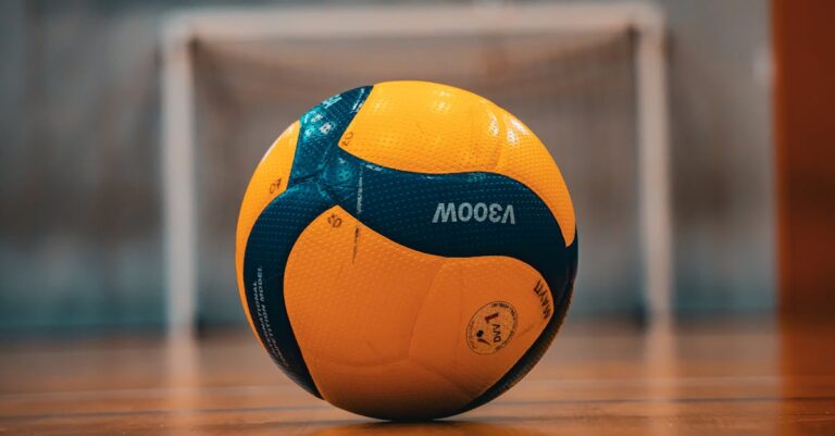 A vibrant yellow and blue volleyball on an indoor court in Kyiv, Ukraine.