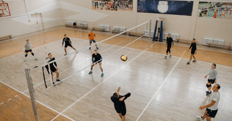 A dynamic volleyball game with athletes actively engaged on an indoor court.