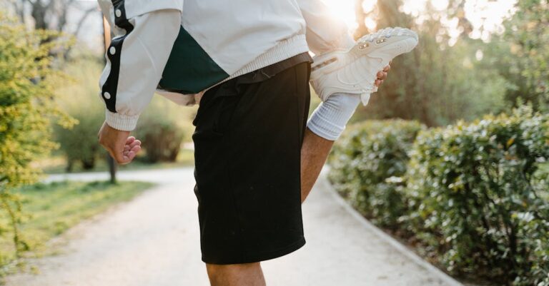 Close-up of a person stretching leg in a sunny outdoor park, ideal for fitness themes.