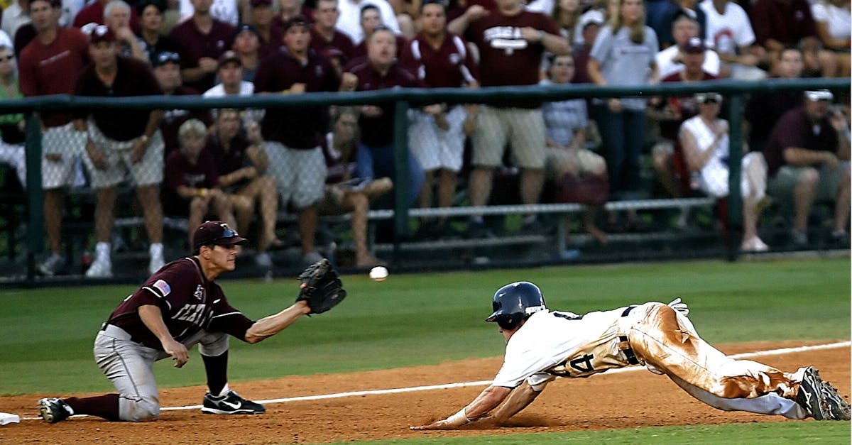 Dramatic moment as a baseball player slides home during a lively game amidst cheering crowd.