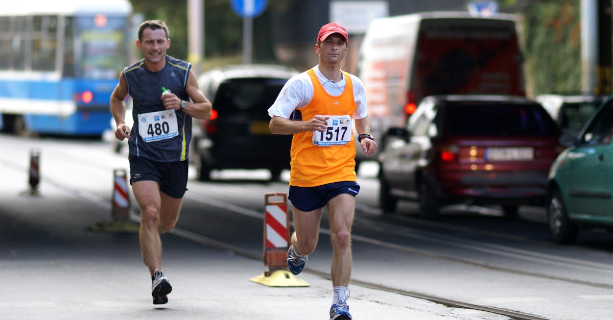 Two men running a marathon through busy city streets, showcasing sport and determination.