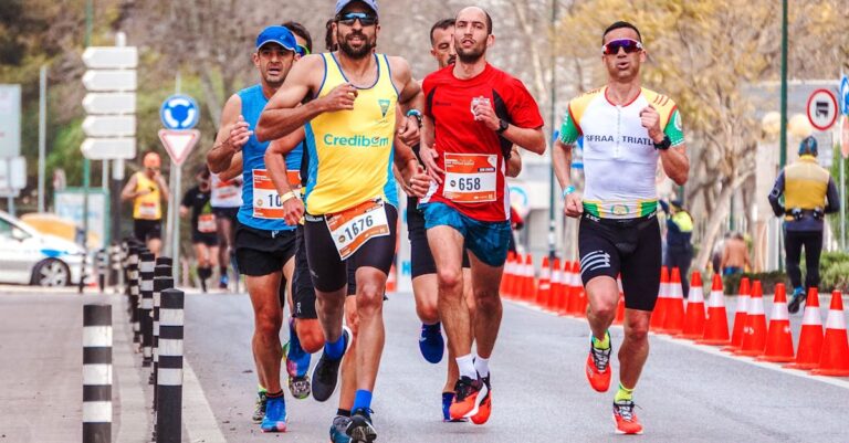 Dynamic scene of a group of male runners competing in an outdoor marathon.