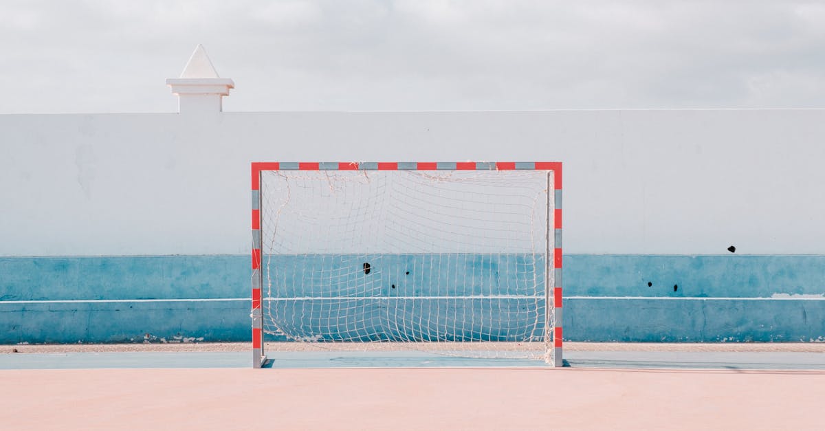 Bright sunny handball court with a vibrant goalpost. Perfect for sports or leisure themes.