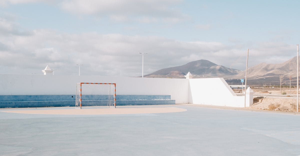 Empty outdoor soccer field with a striking mountain view, ideal for sports and leisure concepts.