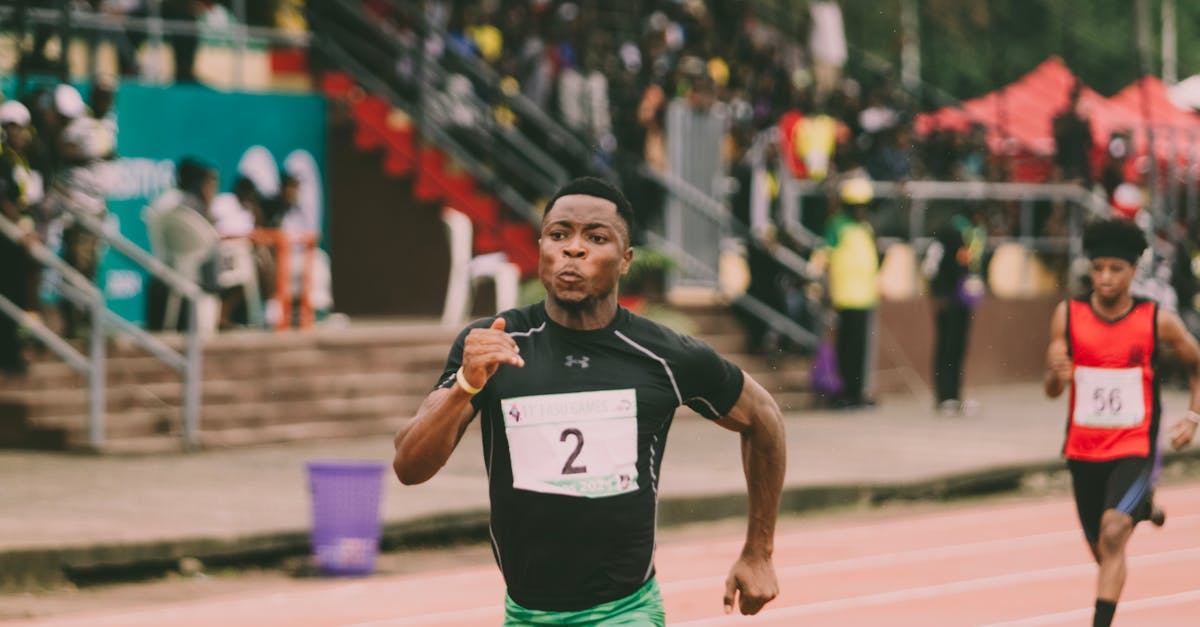 Athlete in green shorts sprinting on track, racing towards victory