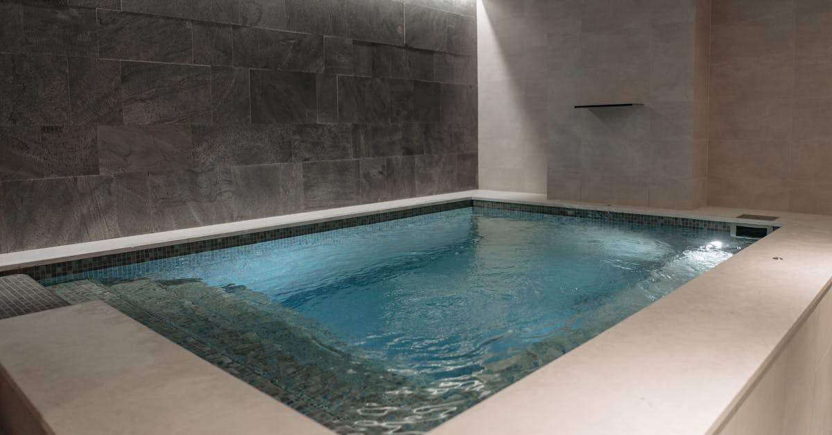 Elegant indoor spa pool with modern stone tile interior, perfect for relaxation.