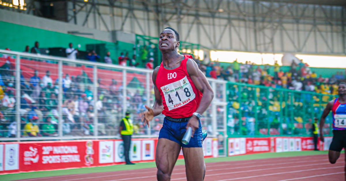 A focused athlete in a relay race at a national sports festival, showcasing determination and speed. pengertian lari estafet, gambar lari estafet